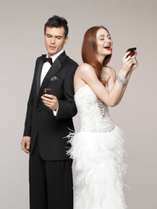 A wedding couple with their smartphone out